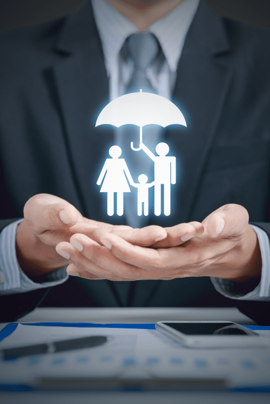 A businessperson in a suit holding an illustration of a family under an umbrella, symbolizing protection, security, and insurance.